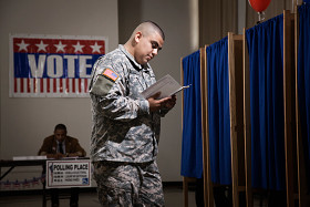 Hispanic soldier waiting to vote in polling place
