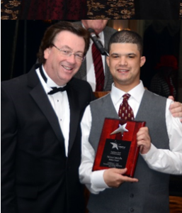 American Training Guest Moises Caraballo smiles for a picture as he receives an employment award from President and CEO Tom Connors at the organization’s second annual Celebrate Good Times Gala on May 16 at Andover Country Club. Photo by Mike Mears.