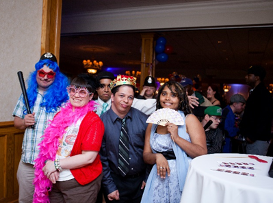 American Training Guests (L to R) Gregory Trepanier, Margaret “Megahn” Johnston, Miguel Colome, Gualberto “Tito” Rodriguez, and Fransuas Gonzalez enjoy the photo booth props at American Training’s second annual Celebrate Good Times Gala at the Andover Country Club on May 16. Photo by Felix Khut.