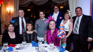 American Training Colleagues and friends smile big at the organization’s second annual Celebrate Good Times Gala, held May 16 at the Andover Country Club. (L to R, seated) Colleagues Maxine Pierce, Lorraine McLarney, and Renee Ghembaza. (L to R, standing) Steve McLarney and Colleagues Steve Pellerin, Kevin Cleary as Austin Powers, Karen Grundy and Al Porter. Photo by Felix Khut.