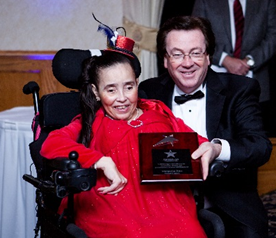 American Training Guest Margarita Rios smiles with President and CEO Tom Connors as she receives the Good Citizenship Award for her dedication to serving others and her community at the organization’s second annual Celebrate Good Times Gala, held May 16 at the Andover Country Club. Photo by Felix Khut. 