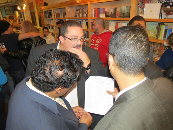 Marcos Devers (l) Campaign manager Dan Mackland Rivera (facing camera) and Abel Vargas look at the results in "shock". 