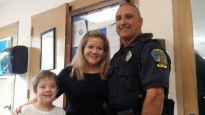Methuen resident Christine Prescott with  her son thanking Methuen Police Officer Torrisi for saveing her life 