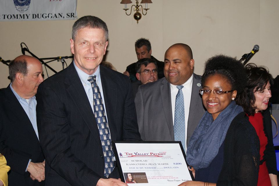 GLTS Student Kassandra Jean Marie with Mr. Hollingshead, administrator of the GLTS. In the background are Lawrence Mayor Dan Rivera and famous weatherman Al Kaprielian 