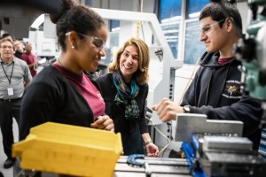 Senior Advanced Manufacturing students Derolin Gonzalez, left, and Nilson Hernandez, right, show a milling machine to Lt. Governor Karyn Polito, center. (Courtesy Photo Greater Lawrence Tech)